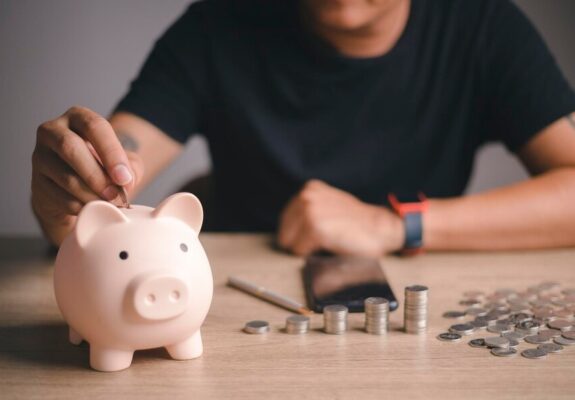 businessman-putting-coin-piggybank-table-donation-saving-charity-family-finance-plan-concept-fundraising-superannuation-investment-financial-crisis-concept_29488-4007